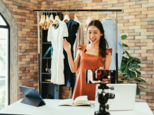 Girl talking in front of clothes on camera to help answer the question do influencers need to pay taxes on gifts? 