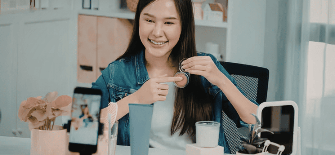 Why TikTok Shop Creators Need an EIN (And How to Get One) A girl sitting at a desk making a TikTok video about makeup.