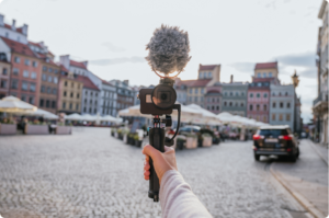 A camera being held up by someone who needs to learn about Travel Write-Offs for Content Creators